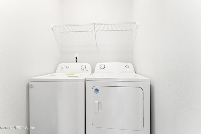 laundry room with washing machine and clothes dryer