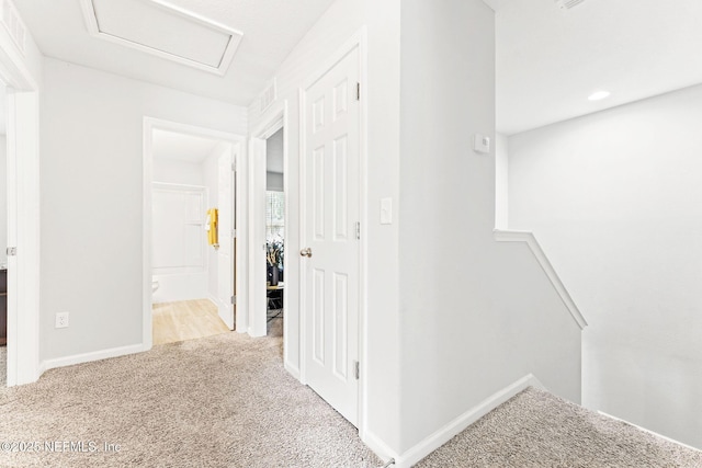 hallway featuring light colored carpet