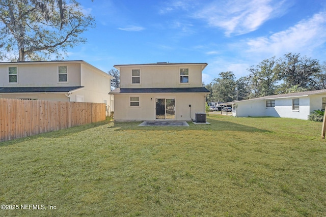 back of property with a lawn and central air condition unit