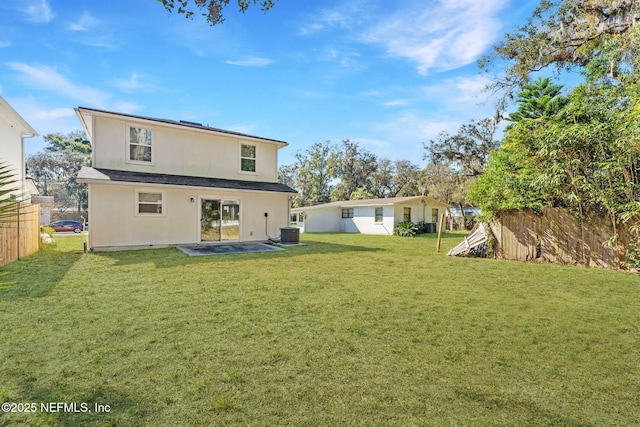 back of house featuring a patio area, central AC, and a lawn