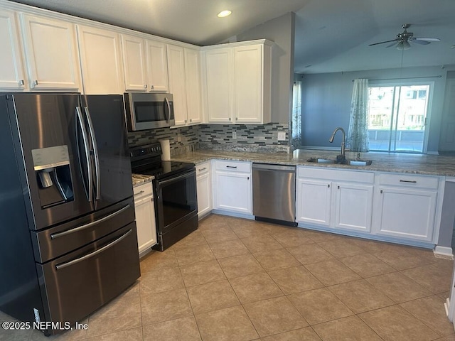 kitchen featuring white cabinetry, appliances with stainless steel finishes, sink, and light stone counters