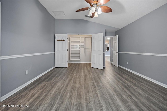 unfurnished bedroom with vaulted ceiling, dark hardwood / wood-style floors, ceiling fan, and a closet