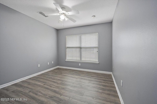 spare room featuring hardwood / wood-style flooring, ceiling fan, and a textured ceiling