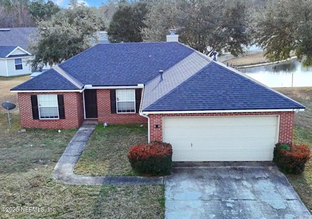 view of front of property featuring a garage and a front lawn