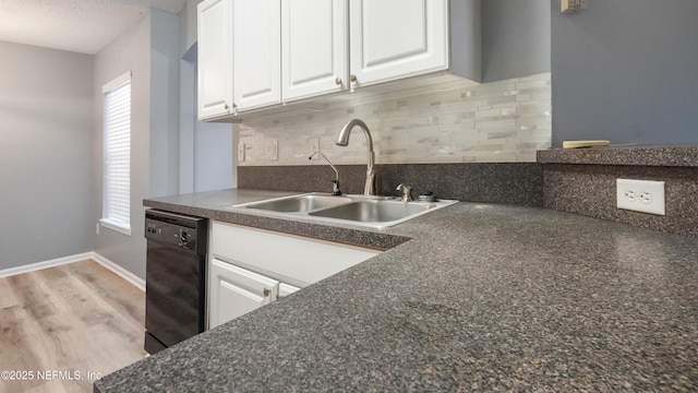 kitchen with sink, light hardwood / wood-style flooring, dishwasher, white cabinets, and decorative backsplash