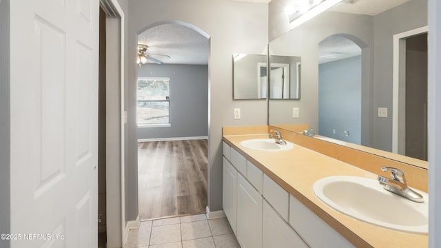 bathroom featuring ceiling fan, tile patterned floors, a textured ceiling, and vanity