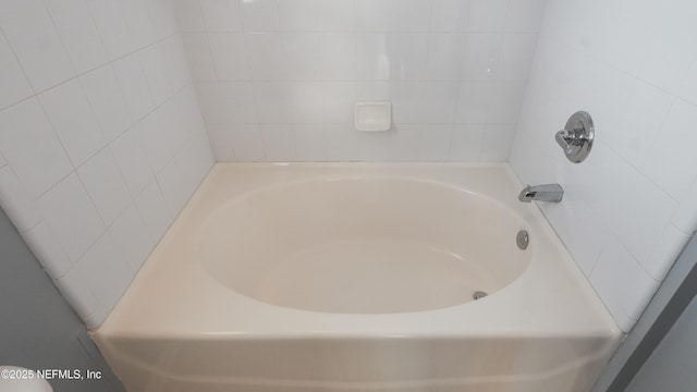 bathroom with a tub to relax in