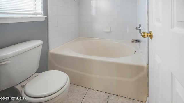 bathroom featuring tub / shower combination and toilet