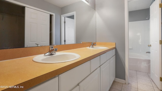 bathroom featuring vanity, tile patterned floors, and shower / tub combination