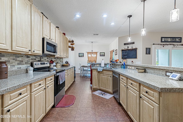 kitchen with pendant lighting, stainless steel appliances, and light brown cabinets