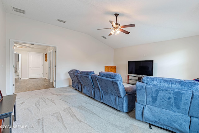 home theater room featuring a textured ceiling, vaulted ceiling, ceiling fan, and carpet flooring