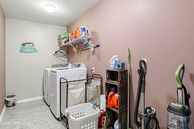 laundry room with washer and dryer and a textured ceiling