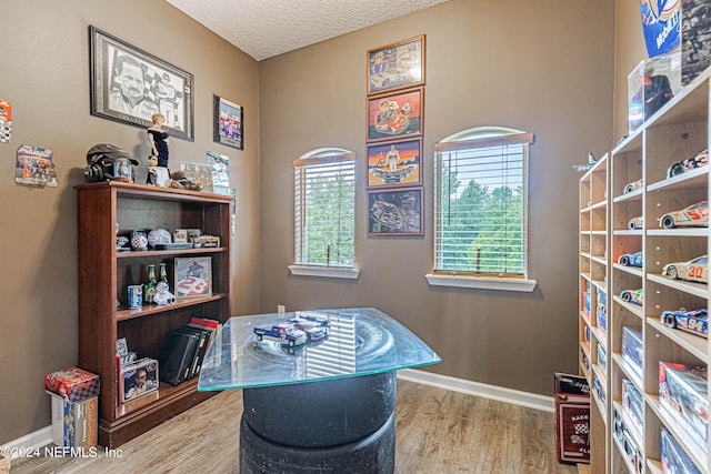 misc room with hardwood / wood-style floors and a textured ceiling