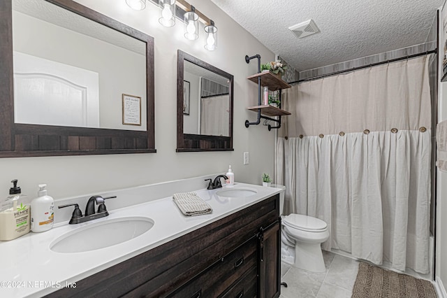 bathroom with vanity, walk in shower, a textured ceiling, and toilet