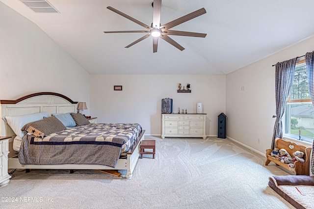 bedroom with ceiling fan, lofted ceiling, and light carpet