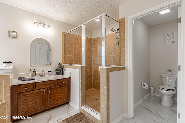 bathroom with walk in shower, vanity, toilet, and a textured ceiling