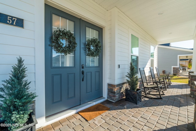 view of exterior entry with covered porch