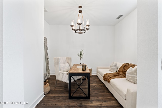 living area with dark wood-type flooring and a notable chandelier