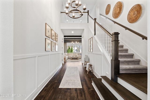 foyer featuring dark hardwood / wood-style flooring and a notable chandelier