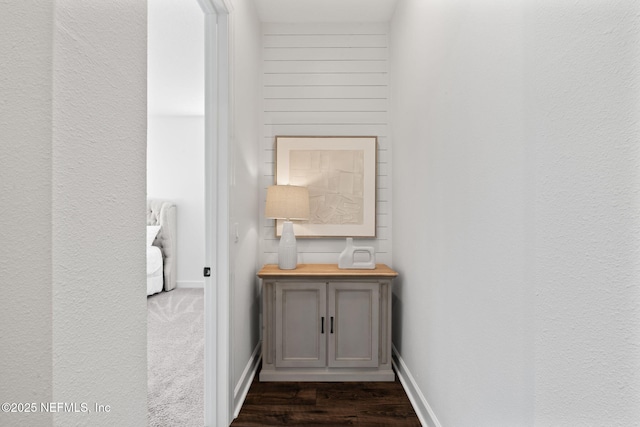 hall with dark wood-type flooring