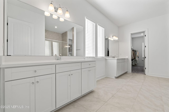 bathroom featuring vanity, tile patterned floors, and a shower with door