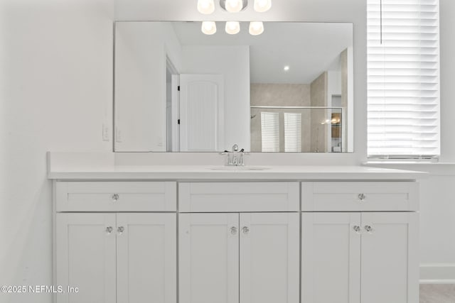 bathroom featuring an enclosed shower and vanity