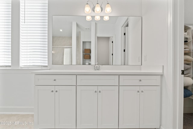 bathroom with a shower with door and vanity