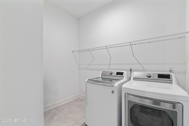 laundry area with light tile patterned flooring and separate washer and dryer