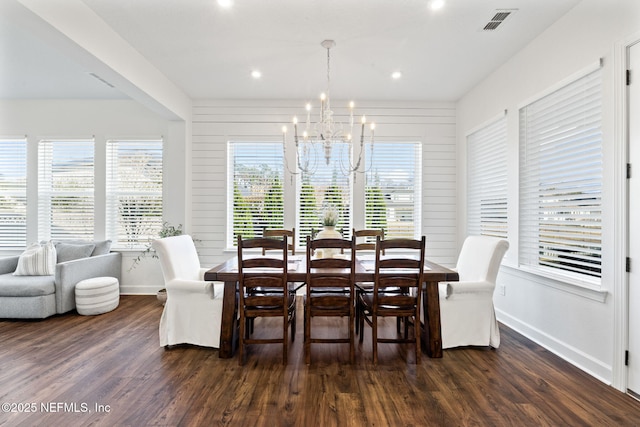 dining room featuring a notable chandelier and dark hardwood / wood-style flooring