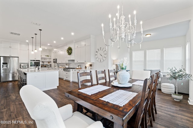 dining space featuring sink, a notable chandelier, and dark hardwood / wood-style floors