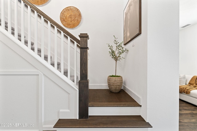 staircase with hardwood / wood-style floors