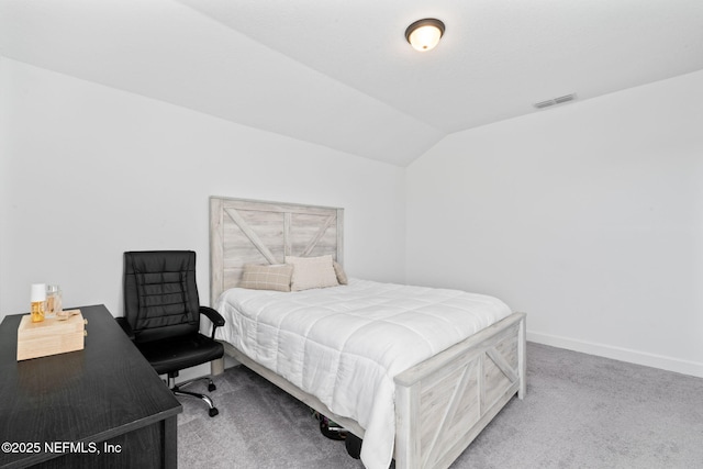 bedroom featuring lofted ceiling and carpet