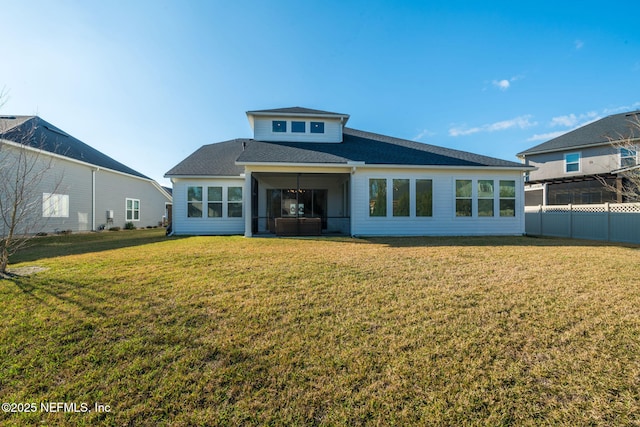 rear view of house with a yard