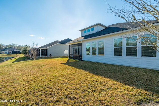 rear view of property with a lawn