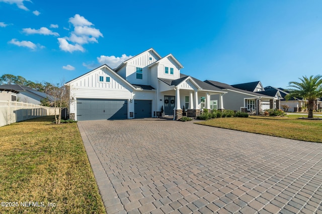 view of front of property featuring a garage and a front yard