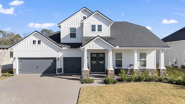 view of front facade with a garage, a front lawn, and covered porch