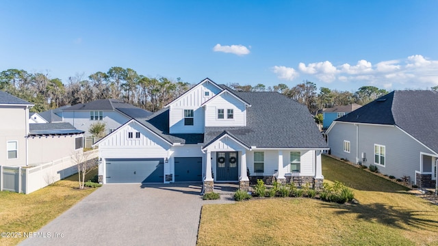 view of front of house with a garage and a front lawn