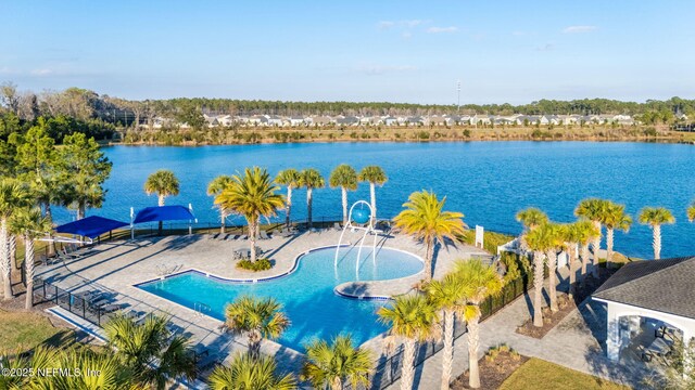 view of swimming pool with a water view and a patio area