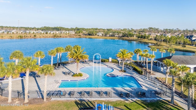 view of swimming pool featuring a water view and a patio area