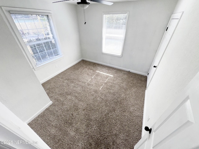 carpeted spare room with ceiling fan