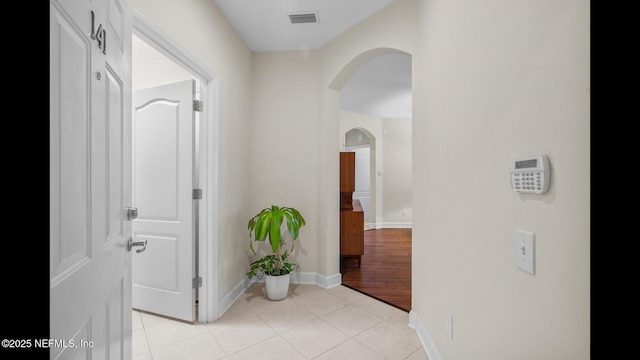 hall featuring light tile patterned floors