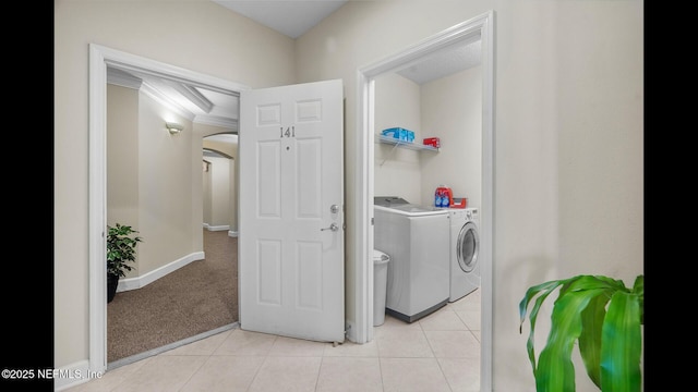 clothes washing area featuring washing machine and dryer and light tile patterned floors