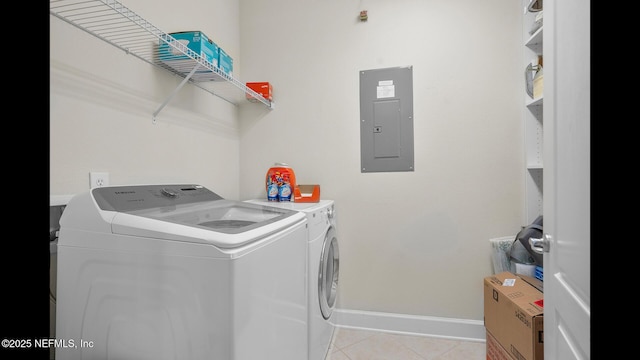 washroom with light tile patterned floors, electric panel, and washing machine and dryer