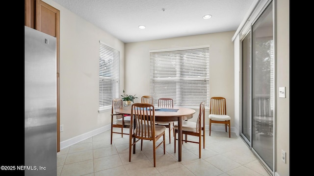 tiled dining room with a textured ceiling