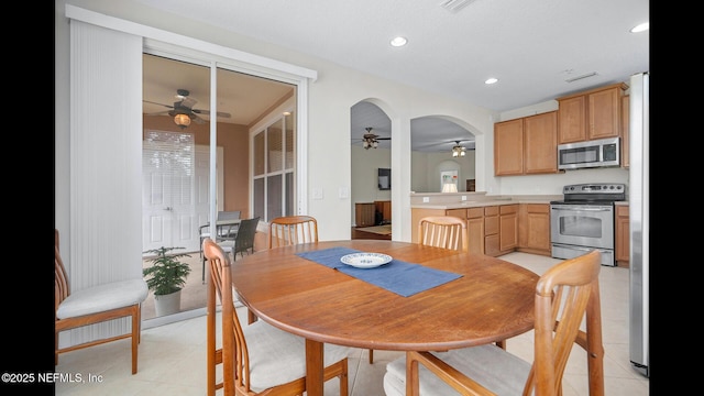 tiled dining area featuring ceiling fan