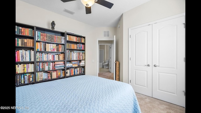 bedroom with light carpet and a closet