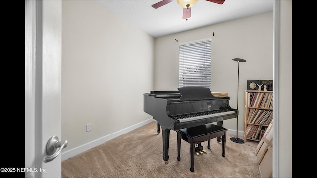 living area with light carpet and ceiling fan