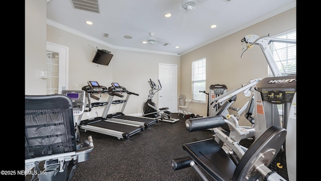 exercise room featuring crown molding