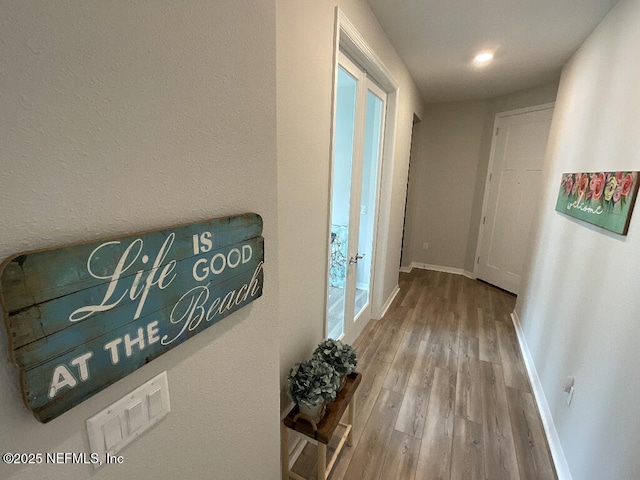 hallway with hardwood / wood-style floors