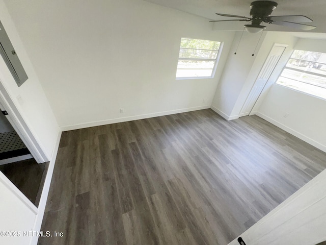 interior space featuring dark wood-type flooring and ceiling fan